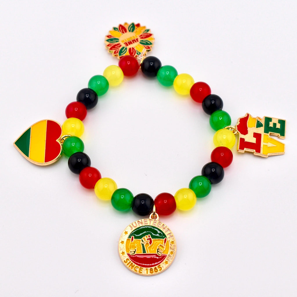 A beaded bracelet with red, yellow, green, and black beads. The bracelet features charms with the words "LOVE", a heart, a sunflower, and a circular charm with the words "Juneteenth Since 1865".