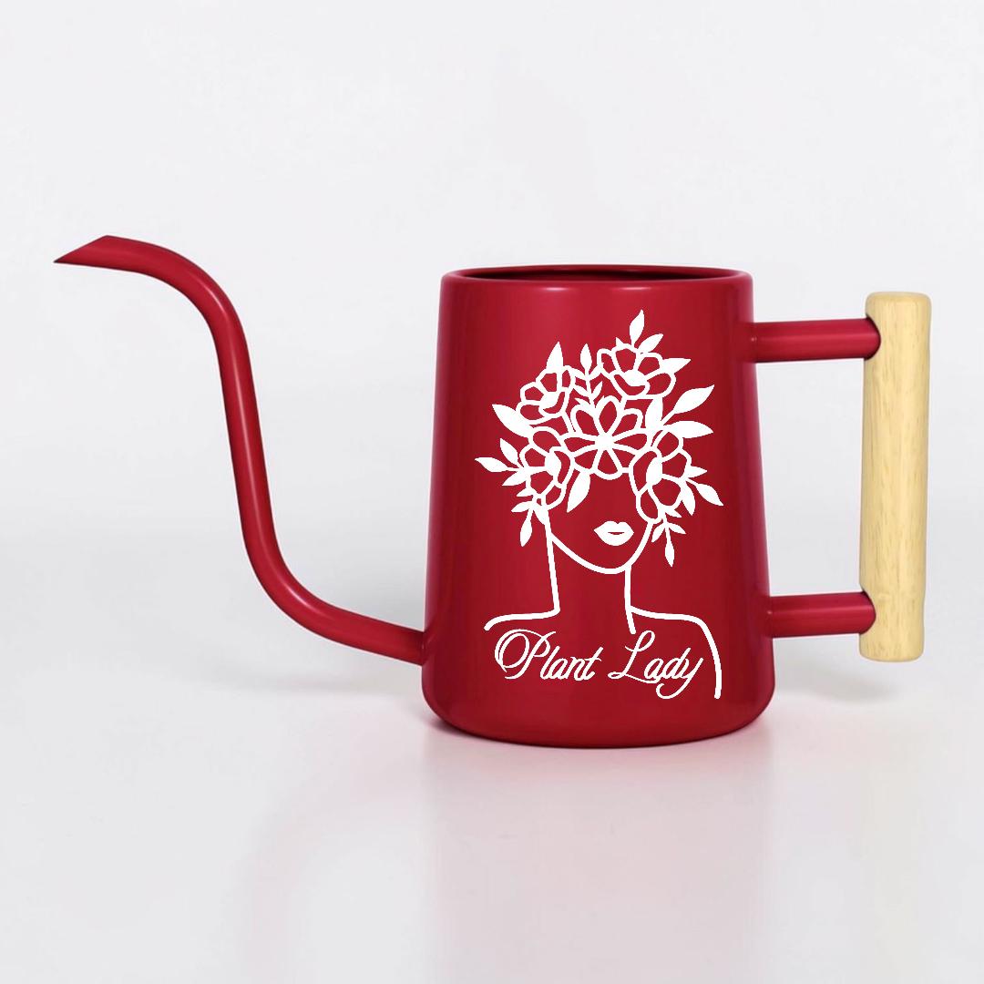 A red watering can with a long, curved spout and a wooden handle. The can features a white graphic of a woman's face with a floral crown and the text "Plant Lady".