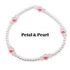 A delicate bracelet featuring small white pearls interspersed with clear crystal beads and larger, round, pink beads. The text "Petal & Pearl" is displayed in black, bold font.