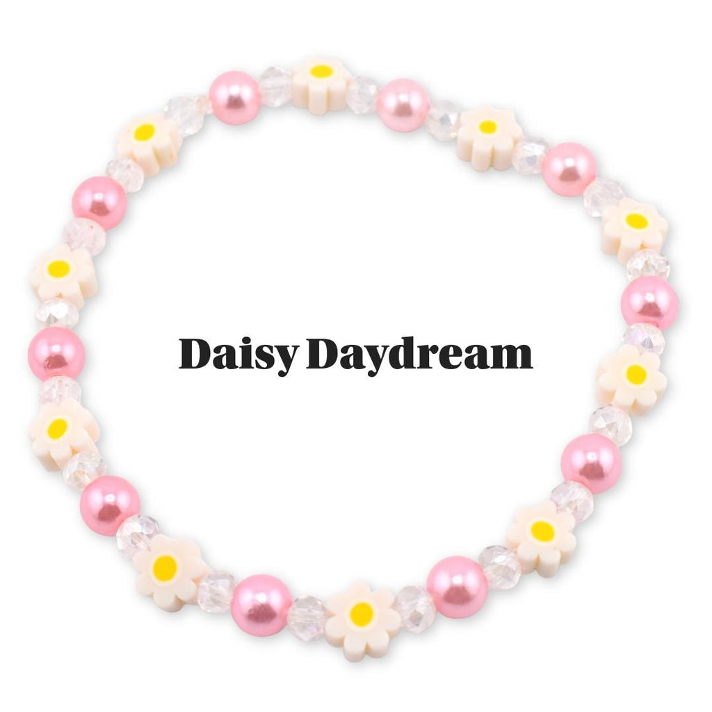 A beaded bracelet featuring pink pearls, clear crystal beads, and daisy-shaped charms with yellow centers. The bracelet has the text "Daisy Daydream" in black.