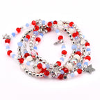 multi-strand beaded bracelets featuring red, white, and blue beads, interspersed with silver-toned metal beads and star charms. The necklace has a patriotic theme, with a mix of round and faceted beads.