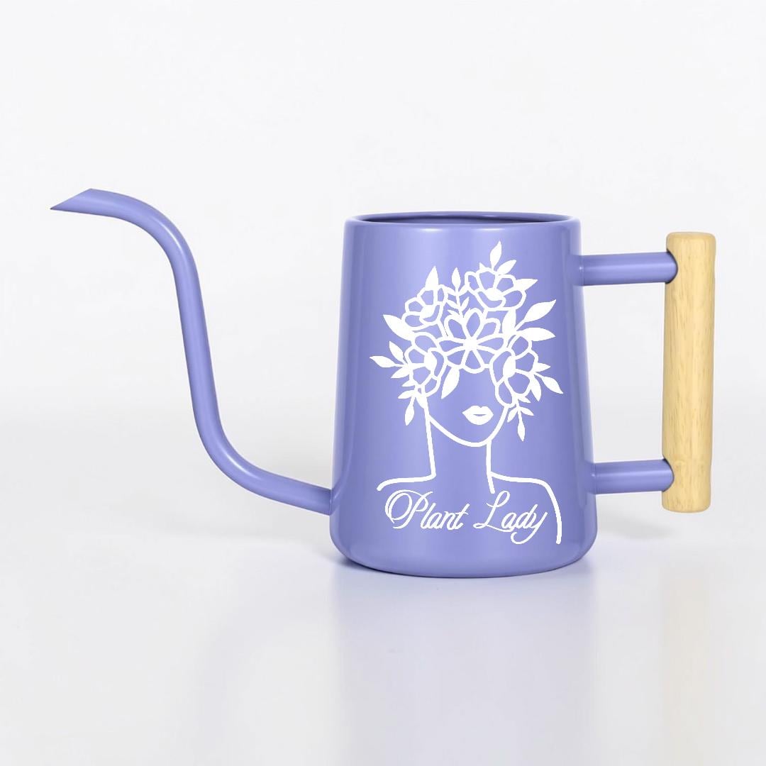 A light purple watering can with a long, curved spout and a wooden handle. The can features a white graphic of a woman's face with a floral crown and the text "Plant Lady".