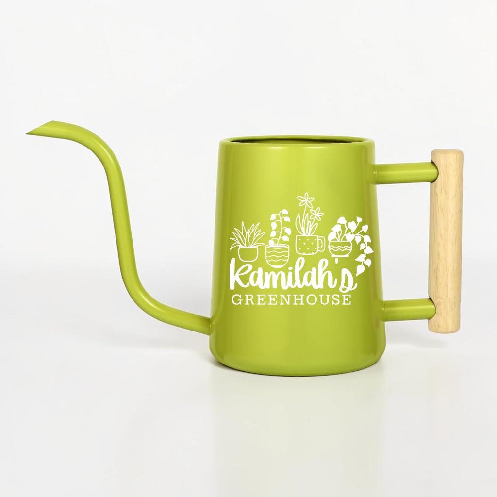 A lime green metal watering can with a long, slender spout and a light-colored wooden handle. The side of the can features a white graphic of four potted plants and the text Kamilah's GREENHOUSE printed in a clean, white font.