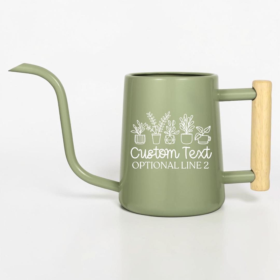 A sage green metal watering can with a long, slender spout and a light-colored wooden handle. The side features a white line art graphic of five potted plants above the text Custom Text and OPTIONAL LINE 2 in a white script font.