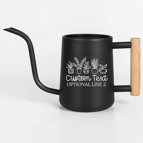 A matte black watering can with a long, slender spout and a light-colored wooden handle. The side of the can features a white line-art graphic of five potted plants above the text Custom Text and OPTIONAL LINE 2 in white font.