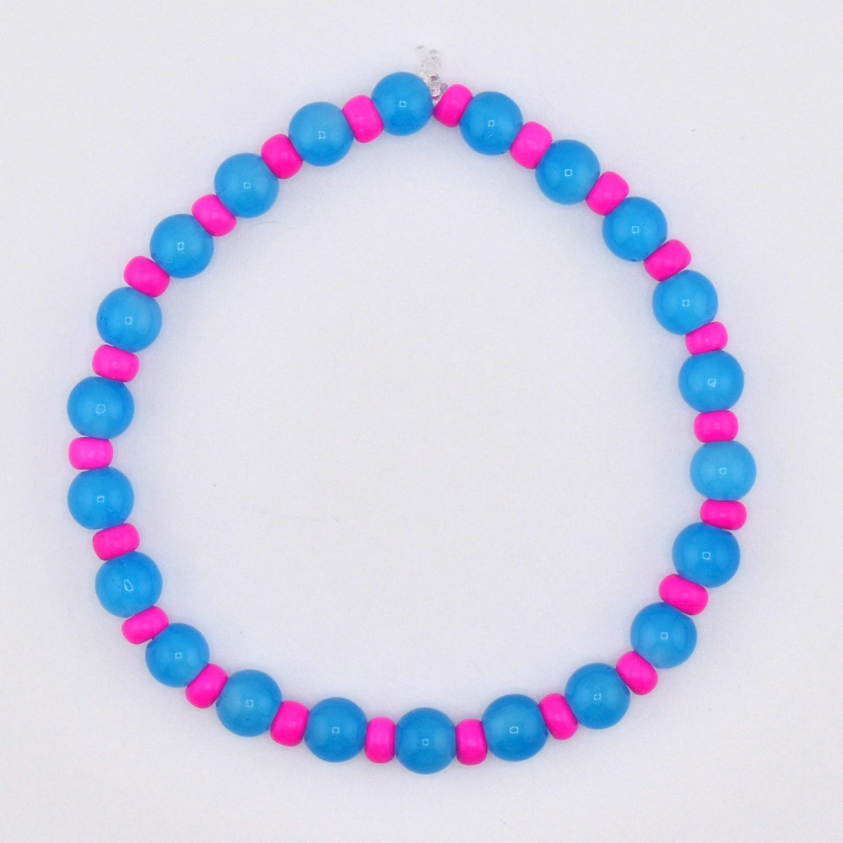 A beaded bracelet featuring alternating blue and pink beads. The bracelet is made of round, glossy blue beads interspersed with smaller, cylindrical pink beads. The design is simple and colorful, suitable for everyday wear.