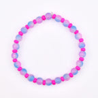 A beaded bracelet featuring alternating pink and blue-purple gradient beads with bright pink spacer beads. The bracelet is strung on a clear elastic cord and is set against a white background.