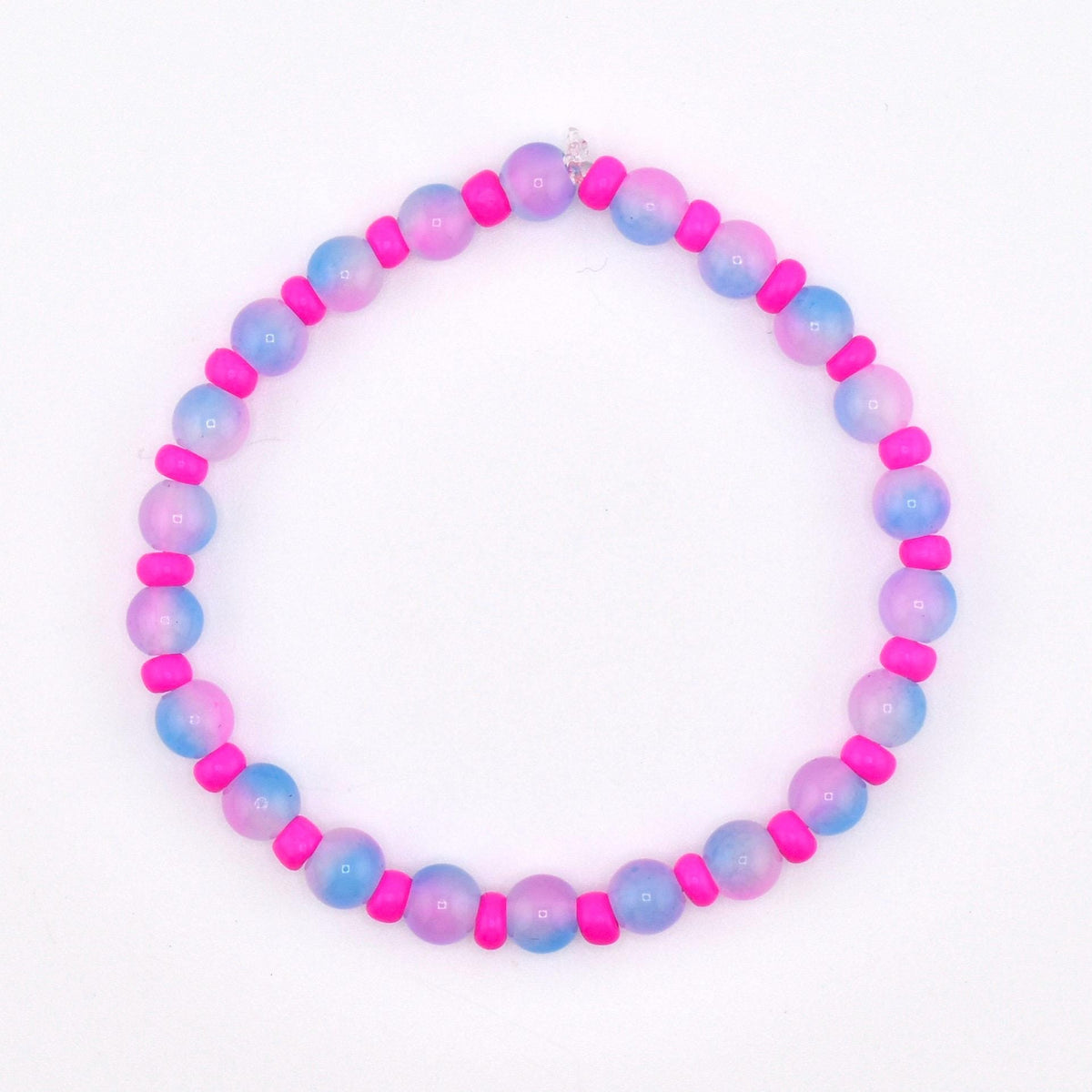 A beaded bracelet featuring alternating pink and blue-purple gradient beads with bright pink spacer beads. The bracelet is strung on a clear elastic cord and is set against a white background.