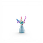 A small, light blue ceramic vase containing a decorative arrangement of colorful beads and butterfly-shaped accents. The arrangement features a pink pearl, a white textured sphere, and purple, blue, and green translucent elements.
