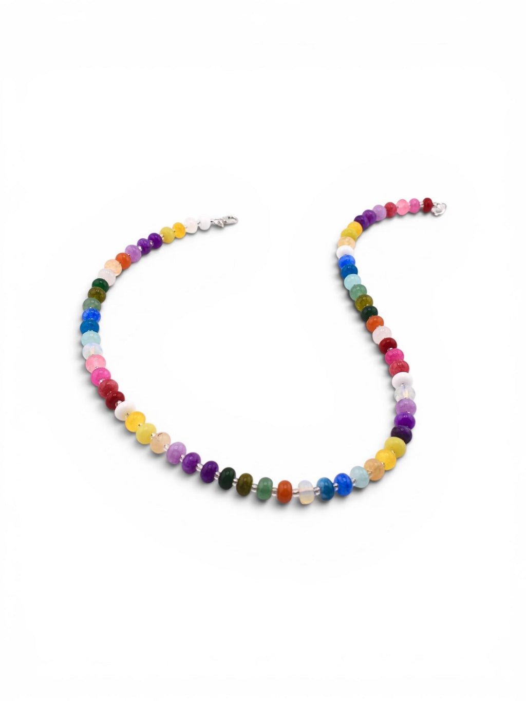 A necklace featuring a continuous strand of small, round, multi-colored gemstone beads in shades of red, orange, yellow, green, blue, purple, pink, and white. The beads are arranged in a vibrant sequence and secured with a silver clasp.