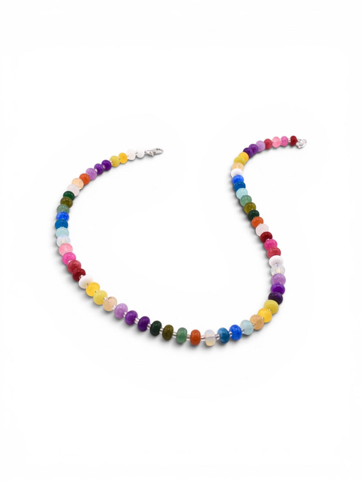 A necklace featuring a continuous strand of small, round, multi-colored gemstone beads in shades of red, orange, yellow, green, blue, purple, pink, and white. The beads are arranged in a vibrant sequence and secured with a silver clasp.