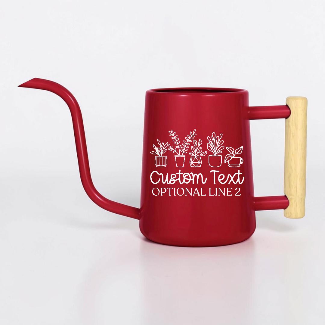 A red metal watering can with a long, thin spout and a light-colored wooden handle. The side features a white line-art graphic of five potted plants above the text Custom Text and OPTIONAL LINE 2 in a white script and sans-serif font.