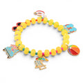 A beaded bracelet featuring yellow translucent disc-shaped beads and small colorful spacer beads. The bracelet includes several metal charms depicting a beach chair with an umbrella, a beach ball, flip-flops, sunglasses, and a floatie.