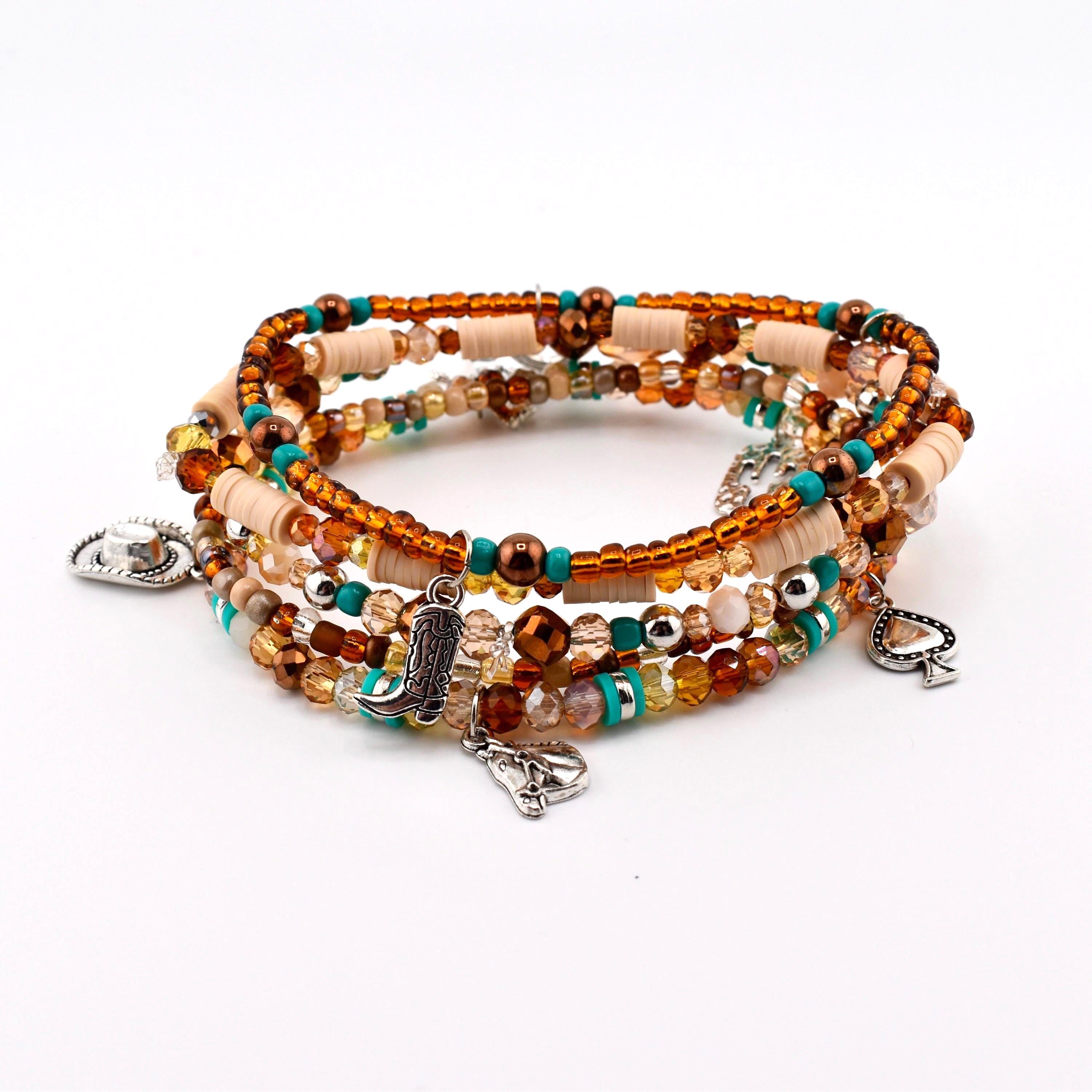 A multi-strand bracelet featuring a mix of brown, tan, and turquoise beads. The bracelet includes silver-toned charms shaped like a cowboy hat, a cowboy boot, a horse head, and a spade symbol, interspersed with faceted glass beads.