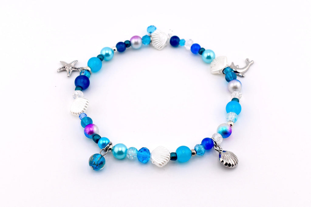 Blue ocean beaded charm bracelet with silver seashell charms, starfish charm and mermaid tail charm, mixed blue navy and turquoise pearl crystal and glass beads – handmade coastal beach bracelet nautical jewelry