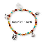 A beaded bracelet featuring faceted orange, yellow, and brown beads interspersed with small turquoise disc spacers. The bracelet includes silver-toned charms shaped like a cactus, a horse, a spade, a cowboy hat, and a horse head.