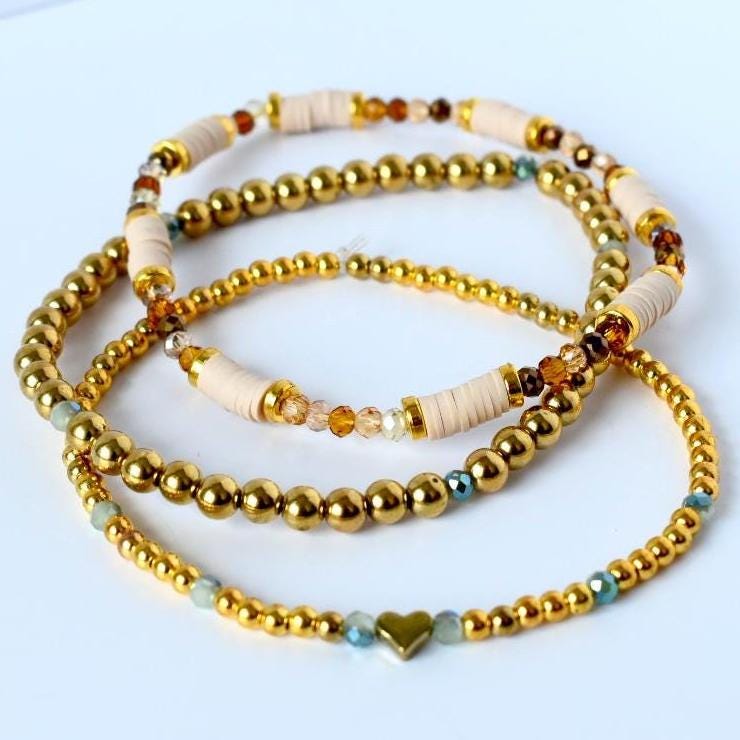 Minimalist tumbler bracelet stack of 3 in soft blush and sage with gold highlights—handcrafted for neutral tumblers and lovers of modern, elegant detail.