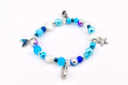 A beaded bracelet featuring a variety of blue, white, and iridescent beads interspersed with silver-toned charms including a mermaid tail, seashells, and a starfish. The circular jewelry piece includes a small metal lobster claw clasp.
