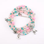 A multi-strand beaded bracelet featuring pink and turquoise beads, clear faceted crystals, and silver-toned charms including a spider, a ghost, a spiderweb, and a bat. The bracelet is constructed with various bead shapes and sizes.