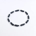 Handmade spooky tumbler bracelet stack – black and gray beads with spider web and skeleton charms for Halloween or gothic cup accessories.
