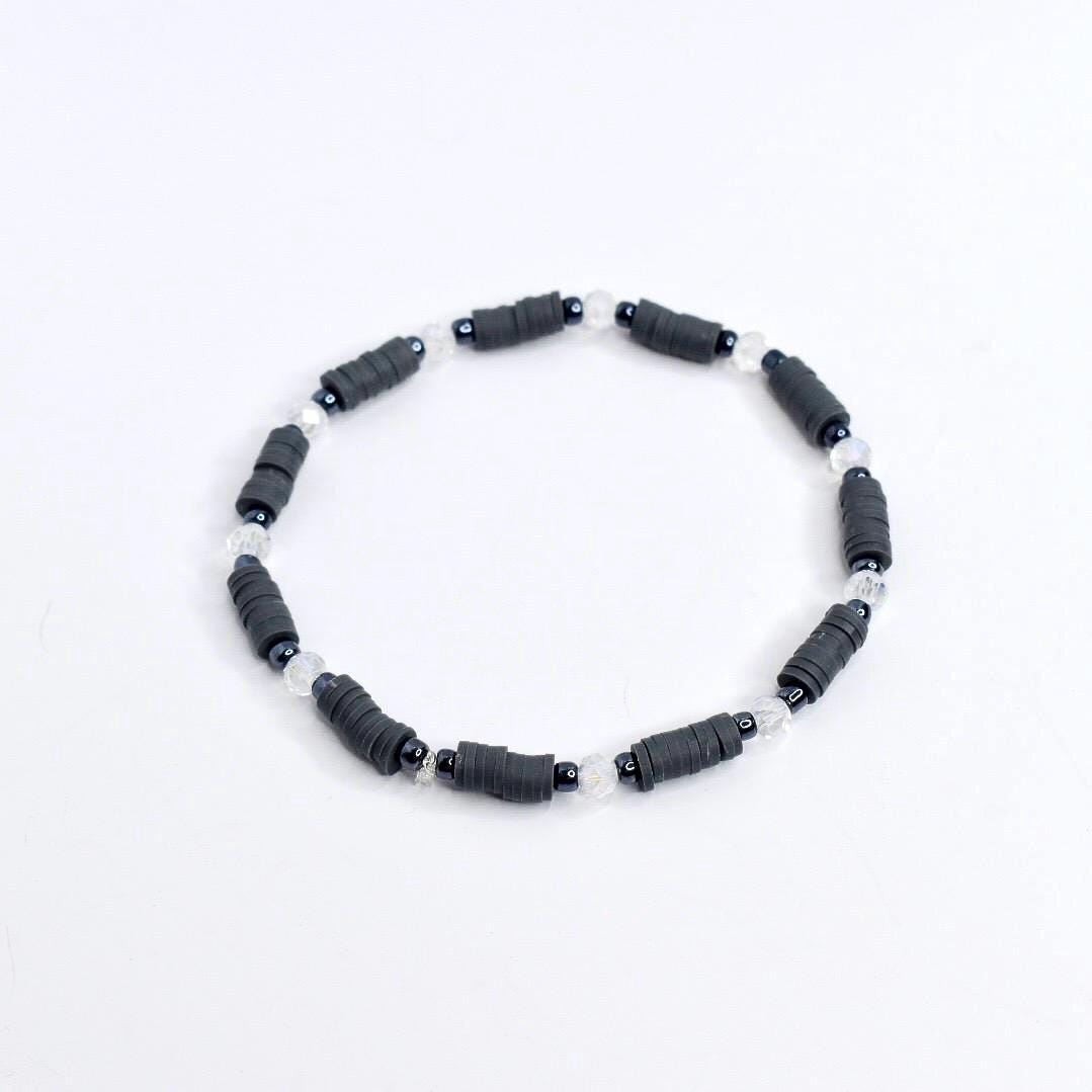Handmade spooky tumbler bracelet stack – black and gray beads with spider web and skeleton charms for Halloween or gothic cup accessories.