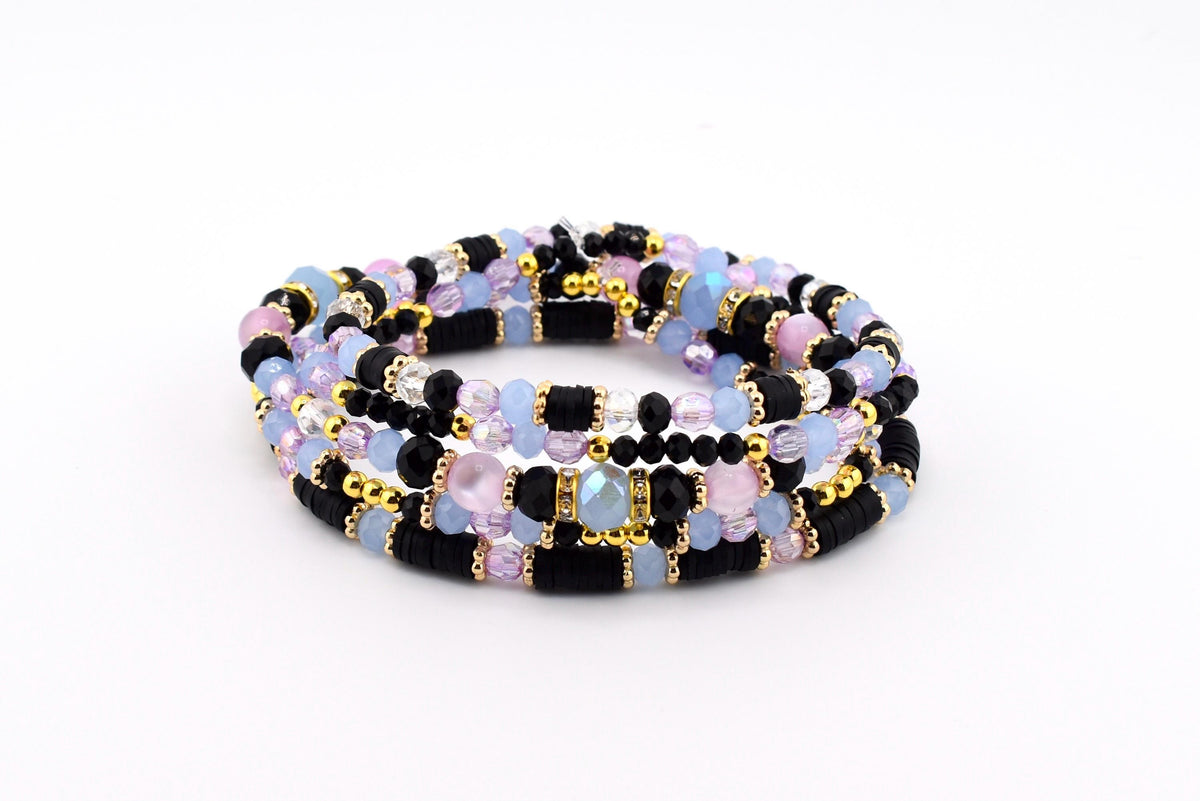 A multi-strand bracelet featuring a combination of black disc-shaped beads, light blue and pink faceted crystal beads, and small gold-toned metallic spacer beads arranged in a repeating pattern to create a layered appearance.