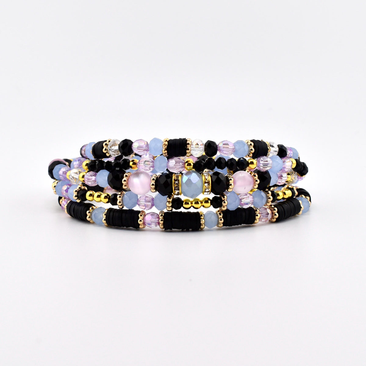 A multi-strand bracelet featuring a combination of black disc beads, light blue round beads, faceted clear crystals, and small gold-toned metallic spacers. The design incorporates alternating textures and colors arranged in a layered pattern.