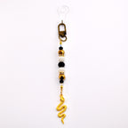 Black and Gold Snake or Moth Straw Charm