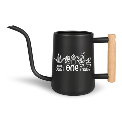 Black ceramic mug with wooden handle and plant design on a white background