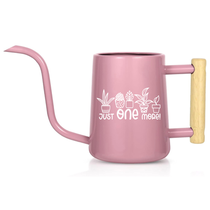 Pink watering can with wooden handle and plant design on a white background