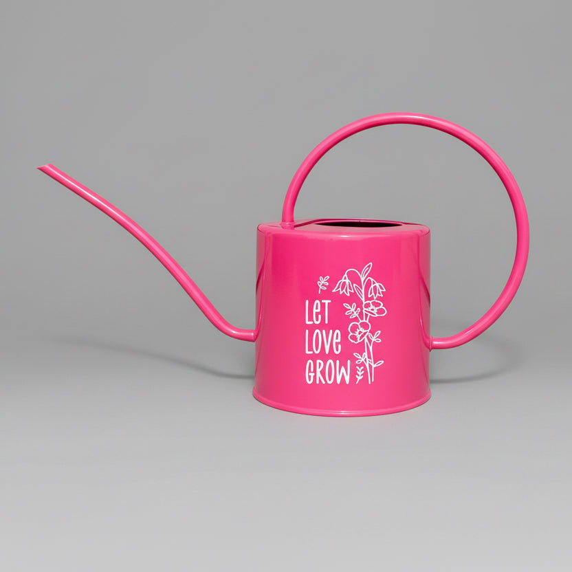 Hot pink watering can with let love grow design in white vinyl on the side.