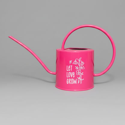 Hot pink watering can with let love grow design in white vinyl on the side.