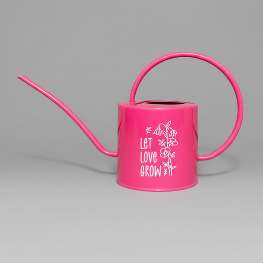 Hot pink watering can with let love grow design in white vinyl on the side.