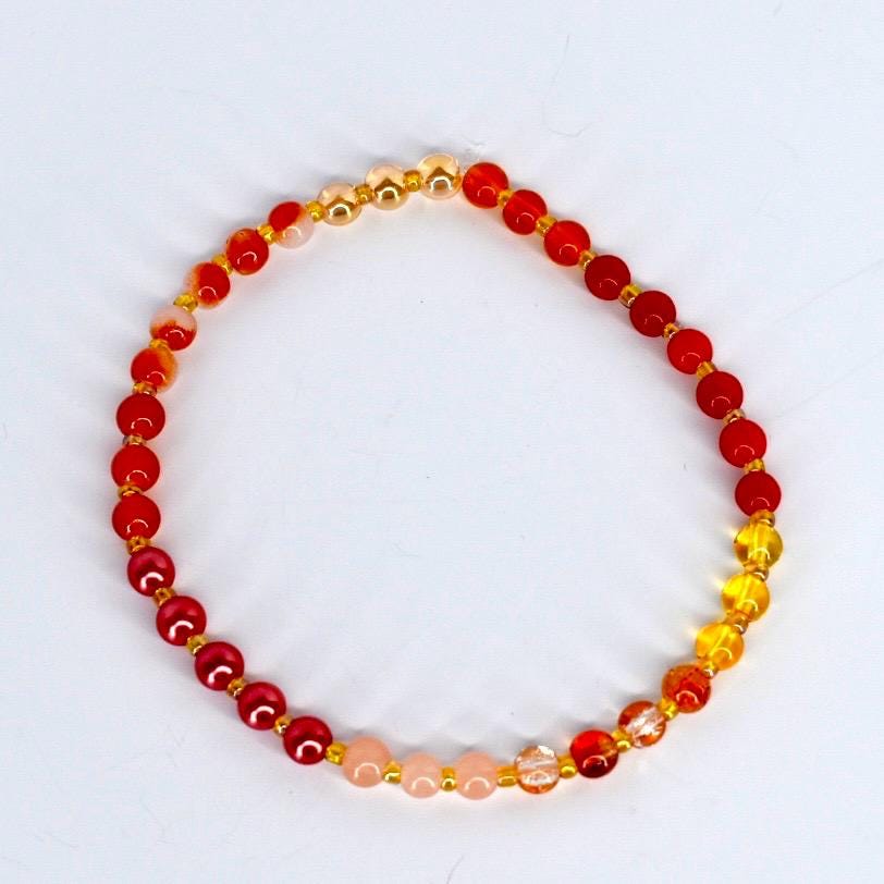 bracelet with orange beads on a white background