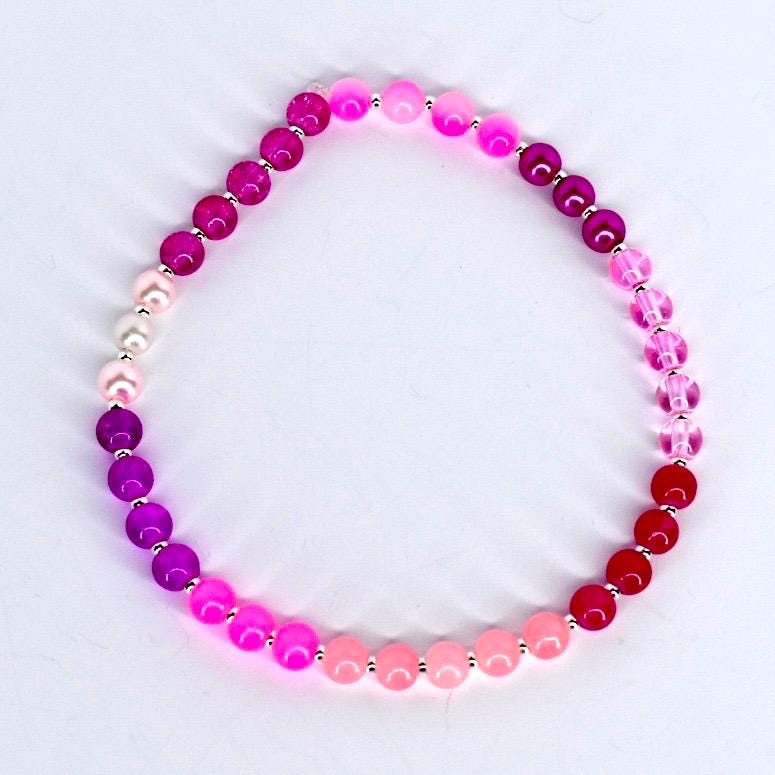Bracelet with pink beads on a white background