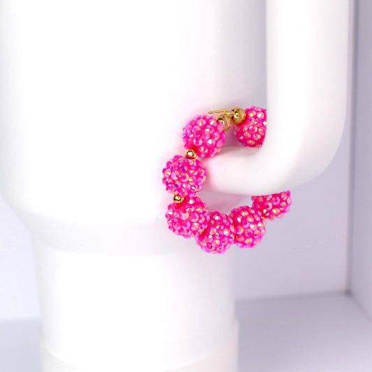 Pink beaded tumbler handle bracelet on a white Stanley tumbler