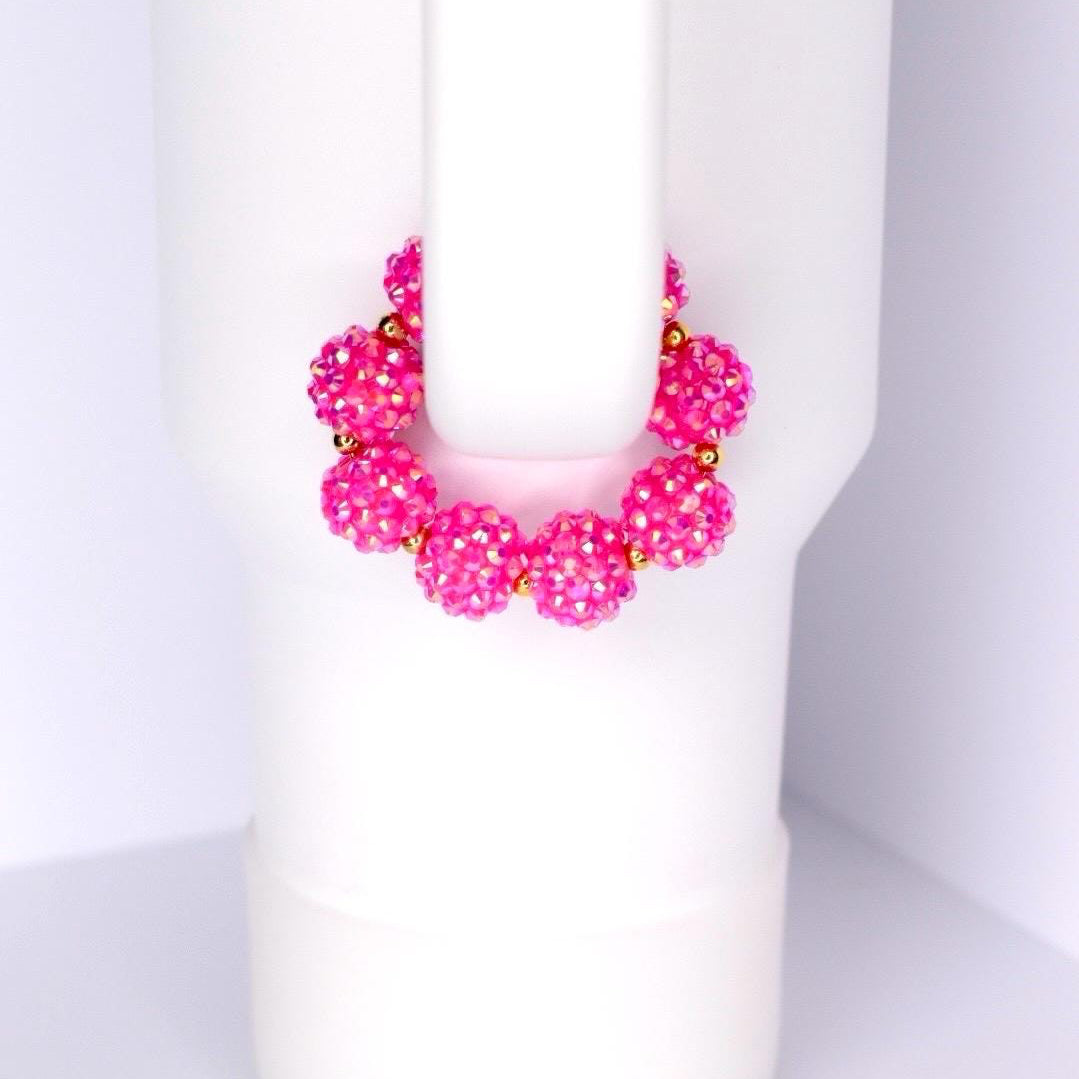 Pink beaded bracelet on a white Stanley tumbler handle