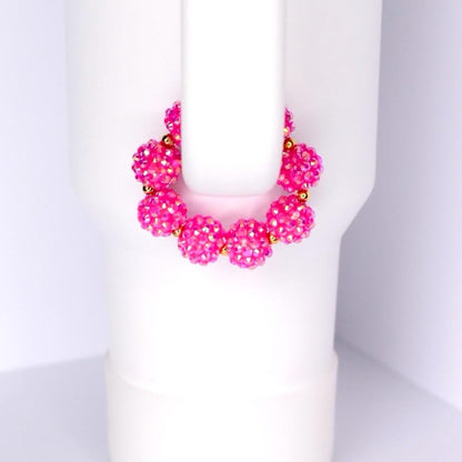 Pink beaded bracelet on a white Stanley tumbler handle