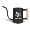 Black metal watering can with a long spout and wooden handle. The can features a white graphic of a potted plant with the words "plant lover" in a script font. Ideal for indoor or outdoor plant care.