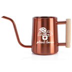 Copper-colored watering can with a long, slender spout and a wooden handle. The can features a white graphic of a potted plant with the words "plant lover" below it. Ideal for indoor plants.