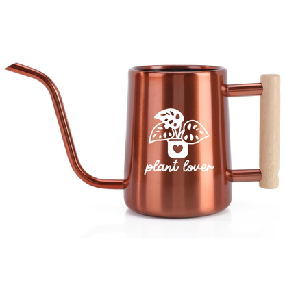 Copper-colored watering can with 'plant lover' design on a white background
