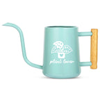 A light teal watering can with a long, curved spout and a wooden handle. The can features a white graphic of a plant in a pot with the words "plant lover" below it. The watering can is designed for indoor plants.