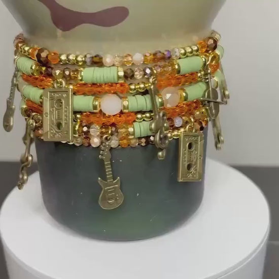 Camouflage Bracelet Stack with Music Charms: Gold, Brown, and Orange Charm Bracelets