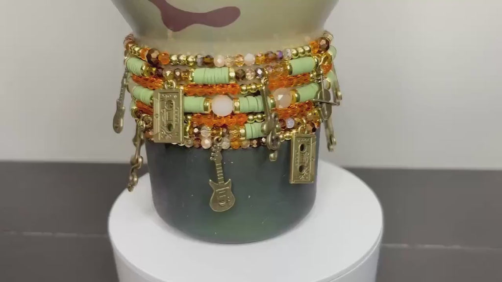 Camouflage Bracelet Stack with Music Charms: Gold, Brown, and Orange Charm Bracelets