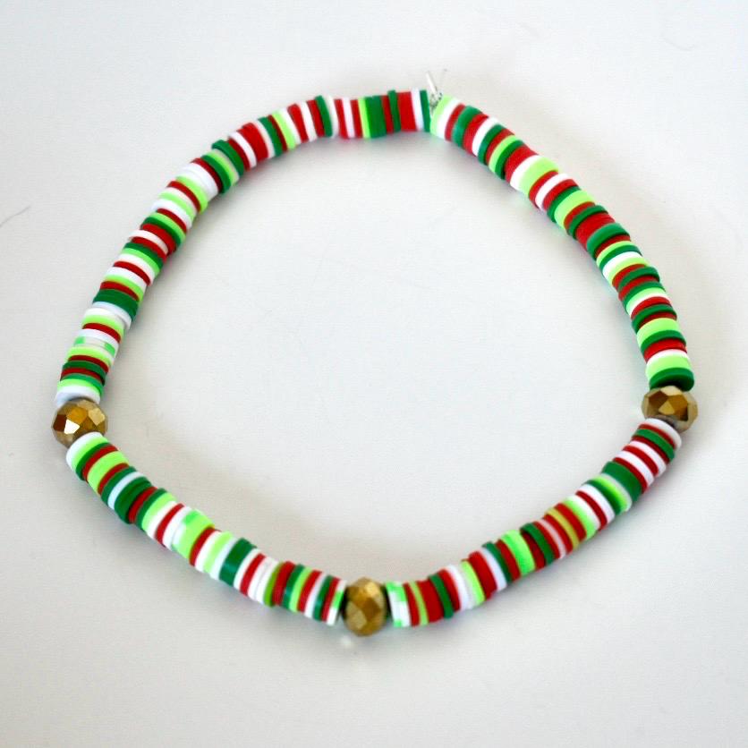 Red green and white beaded necklace on a white background