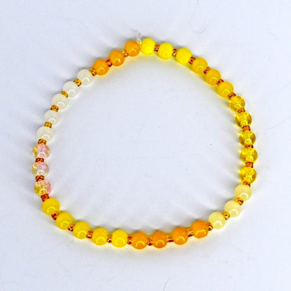 beaded bracelet with yellow beads on a white background